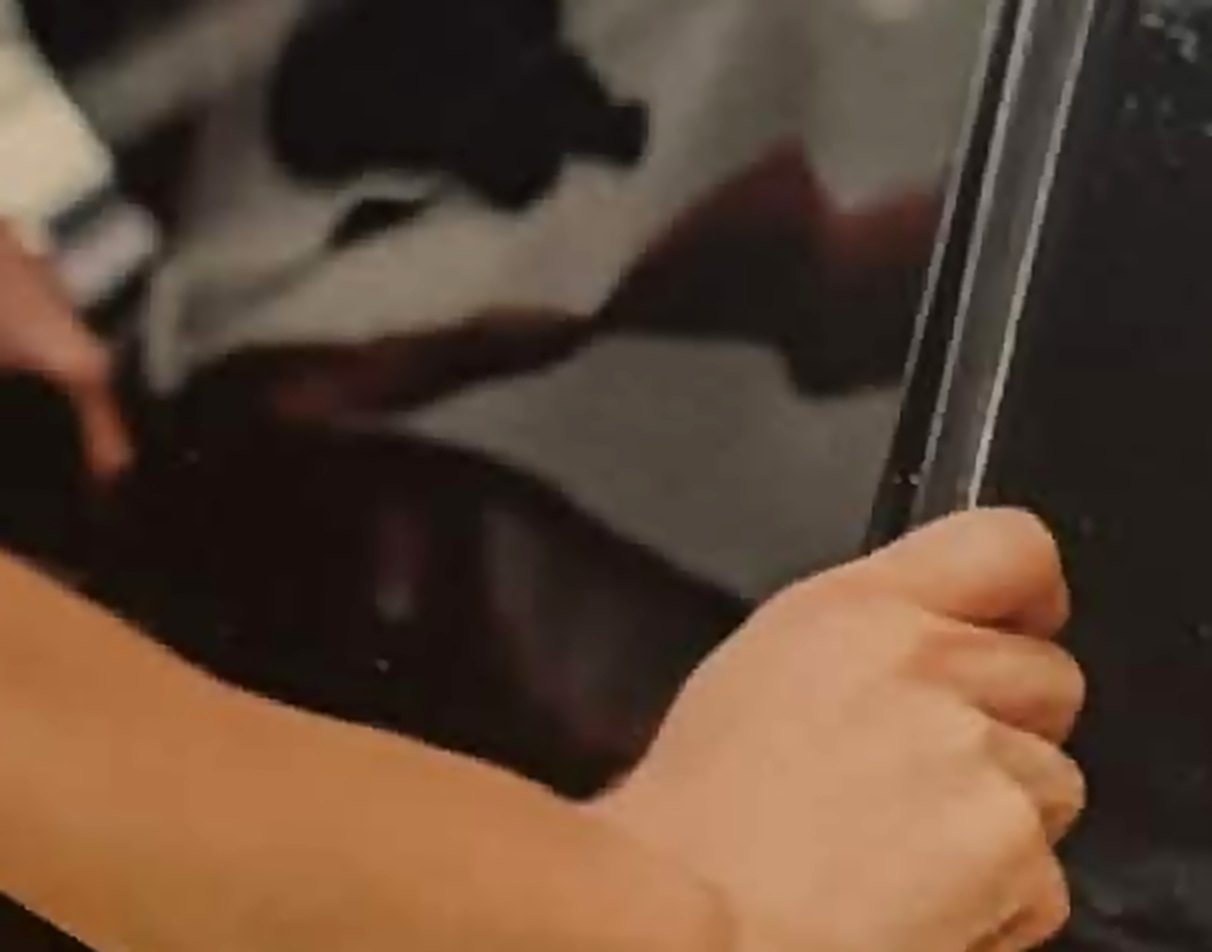 Window film being squeegeed onto a vehicle's door glass during installation