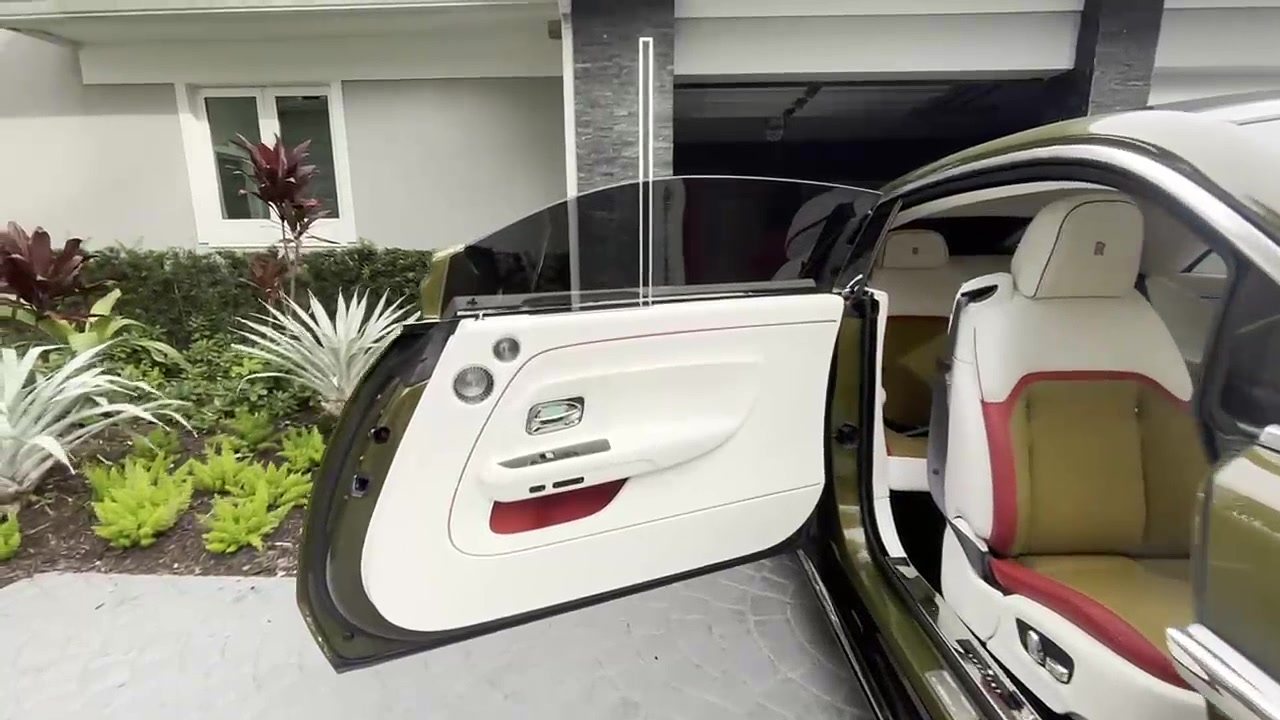 Coach door open on a luxury coupe